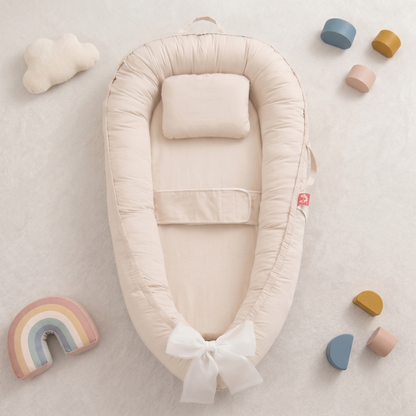 Halo winged baby nest, beige, styled flat lay
