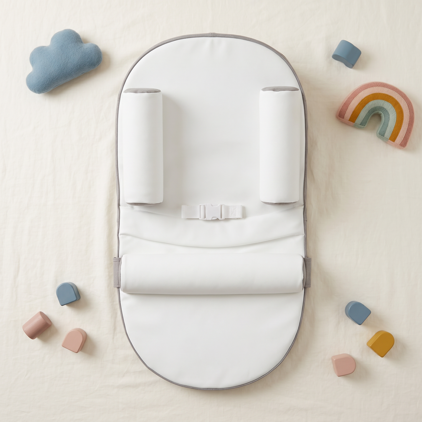 Nestle baby lounger, gray, styled flat lay